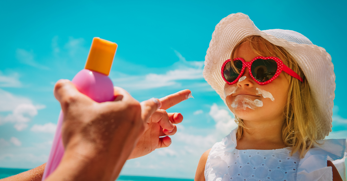 parent applying child's sunscreen